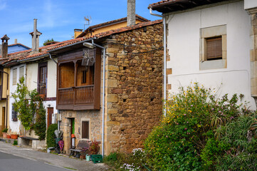 Travelling by car in Asturias, North of Spain. View on village, houses, gardens near Villaviciosa