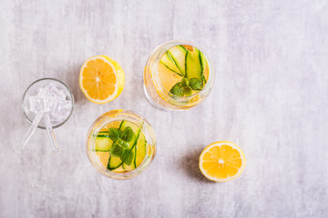 Summer hugo spritz cocktail with champagne, cucumber, lemon and mint in wine glasses top view