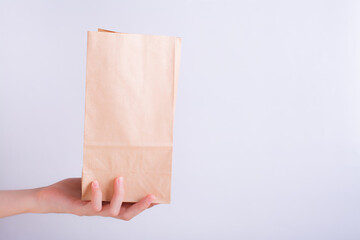 Hand holding disposable recyclable zero waste paper bag