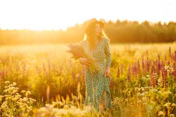 Beautiful woman in the blooming lavender field. Nature, vacation, relax and lifestyle. Summer landscape.