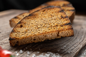 Brown spicy rye croutons sticks, pieces of dry bread. Macro