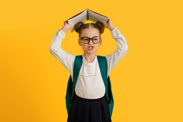 Learning Difficulties. Angry Little Schoolgirl Covering Head With Book