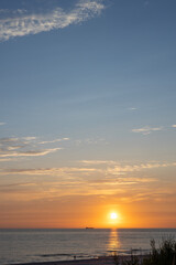 sunset in the sea with colorful sky and clouds on beach