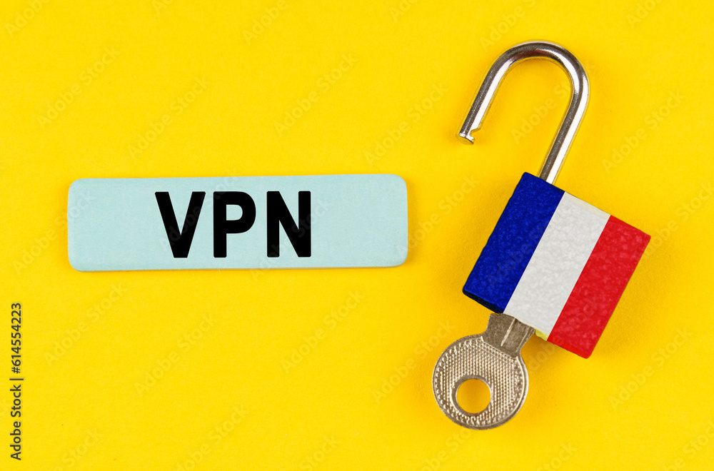 Poster on the yellow surface is an open lock with a key and a sticker with the inscription - vpn
