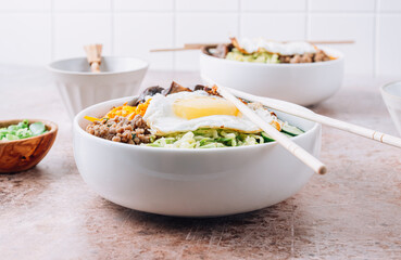 Homemade Korean Bibimbap. Spicy salad with rice, egg, beef and vegetables