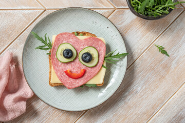 Cute heart shape sandwich with salami and cheese