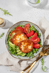 grilled Halloumi cheese, tomatoes, avocado, and arugula. Vegan food Diet menu. Top view. Flat lay.