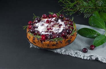 Traditional English Christmas pie with cranberries. Pie on a dark background