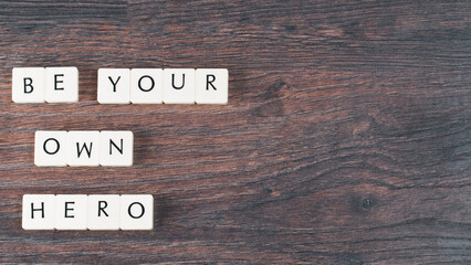 Be your own hero word on white stones. Motivational quote concept. Motivational words on little...