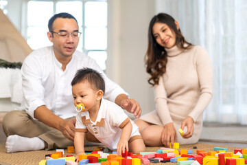 Portrait of enjoy happy love asian family father and mother with little asian baby smiling activity...