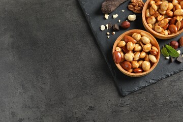 Tartlets with caramelized nuts on black table, top view and space for text. Delicious dessert