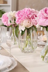 Stylish table setting with beautiful peonies indoors