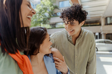 Group of multiracial diverse student  laughing, positive talking near university campus. Young colleagues discussing, planning startup, teamwork. Concept of education, successful business