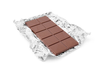 Delicious milk chocolate bar with foil isolated on white