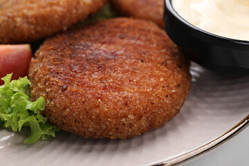 Delicious vegan cutlets on plate, closeup view