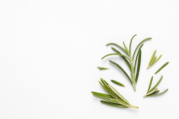 Sprigs of fresh rosemary on white background, flat lay. Space for text