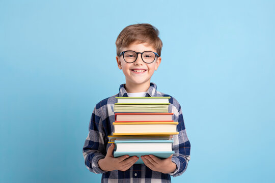 boy holding stacks of books. 