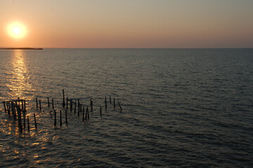 Sunrise overlooking Fishing dock in Cedar Key Florida. On a sunny day with calm waters. Wood pier...