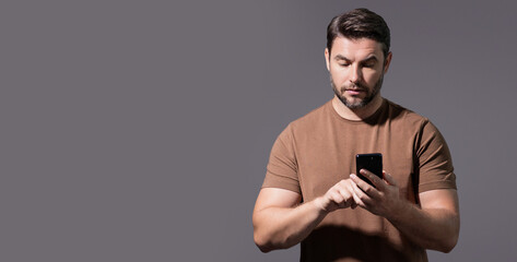 Satisfied business man talking on phone, promo mobile app. Businessman in casual clothes using smartphone isolated over studio background. Banner for header, copy space. Poster for web design.
