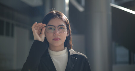 Portrait of Young woman dressed in formal business standing in workplace.