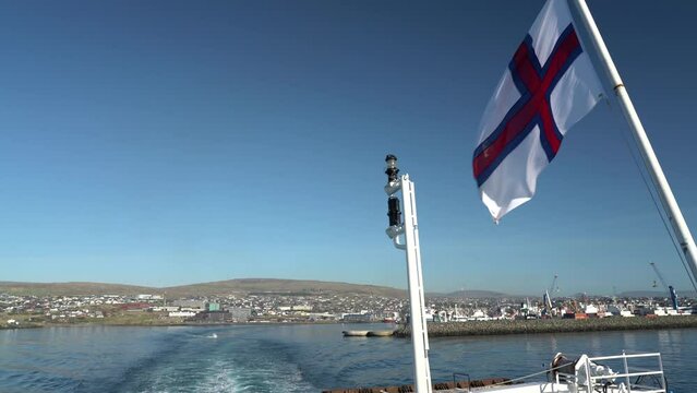 Faroese Flag On A Boat Sailing In Torshavn, Faroe Islands. closeup, wide