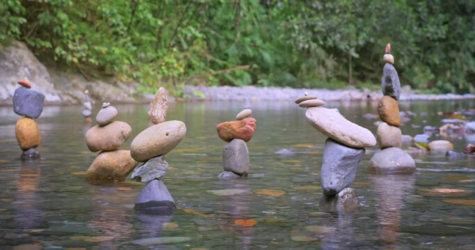 Zen stone pyramids in river tranquil nature landscape. Meditation scene