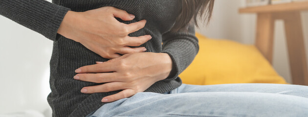 Flatulence asian young woman, girl hand in stomach ache, suffer from food poisoning, abdominal pain...
