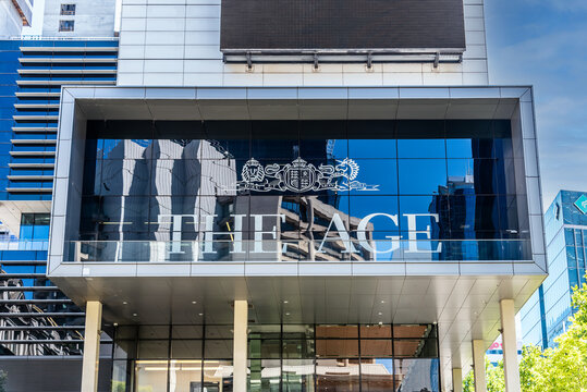 The glass facade featuring the main signage for 'The Age' newspaper head office in the city centre of Melbourne