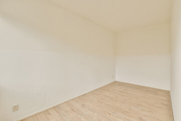 an empty room with white walls and wood flooring the wall is painted in light brown, but there is no one