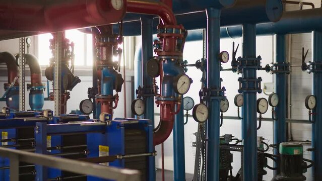Complicated pipeline system and powerful pumps in boiler house. Heat producing equipment installed in modern building. Central heating utilities