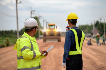 Asian surveyor engineers use tablet to check detail in job,  Control schedule of work of highway...