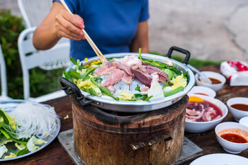 Thai barbecue Grill Pork on hot pan. Barbecue buffet pig pan and vegetables in soup.