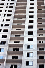 Urban background. Windows and balconies of an abstract unfinished apartment building under construction. 