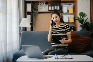 Asian business woman using laptop computer at modern home office