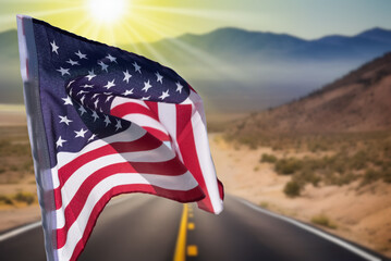 United States flag and road through the American desert