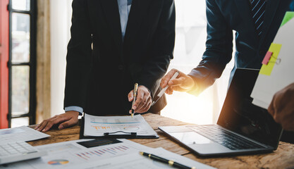 Young colleagues discuss business brainstorming and price charts analyze business people at the desk brilliantly in modern collaborative office teamwork ideas. Calculate personal tax for customers