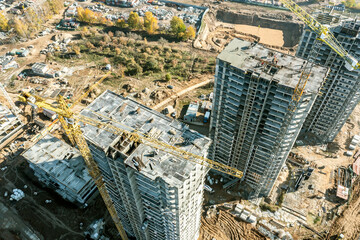 Obraz premium aerial view of a large construction site with buildings under construction and tower cranes.