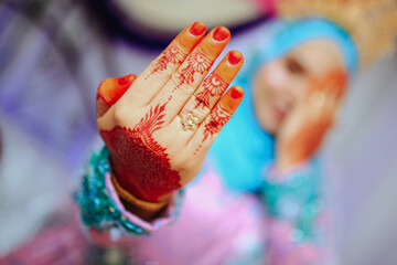 Malay bride's showing henna design and wedding ring.