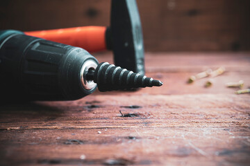 Stepped conical drill on a wooden background close-up.