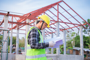 An engineer looking at the unfinished high-roof steel work and analysis of construction projects view designs and order