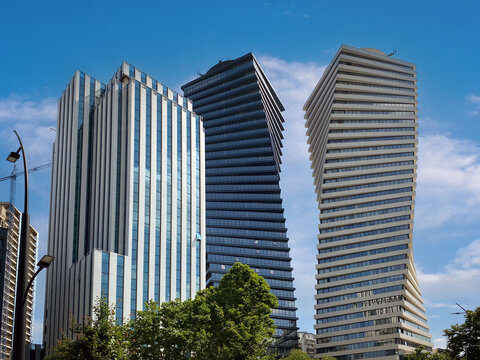 Close-up downtown district of skyscrapers Axis Towers Art Nouveau building against the backdrop of a beautiful sky on Chavchavadze Avenue: Tbilisi, Georgia - June 2, 2023.