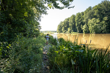 Boy fishing in lake on summer day.