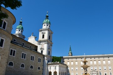 Fototapeta na wymiar Salzburg cathedral from Residenzplatz with Residenzbrunnen fountain in Salzburg city centre in Austria