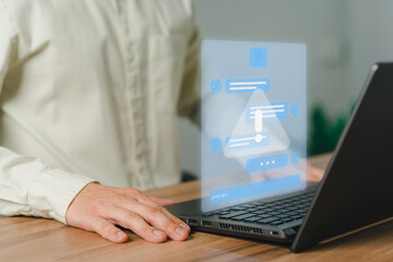 Young man using laptop computer chatting with triangle caution warning sign for notification error concept. Chat with smart AI or Artificial Intelligence technology. Chat bot ai communication.