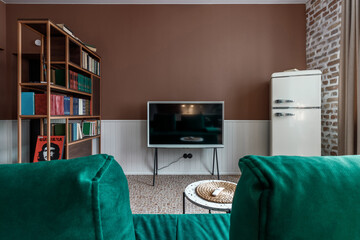 Stylish living room in house with modern retro interior design, velvet sofa, plants, poster mock up...
