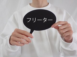 若い男性が持っている吹き出しにフリーターの文字