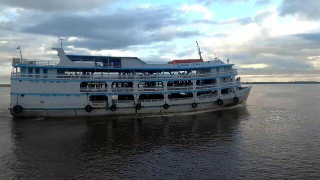 Boat cruise sailing rio Amazonia in amazon rainforest at sunset