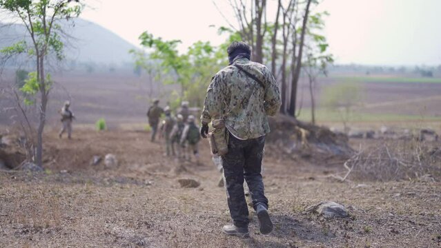 Team of U.S. Army marine corps soldier military war with gun weapon participating and preparing to attack the enemy in Thailand during exercise Cobra Gold training in battle. Combat force.