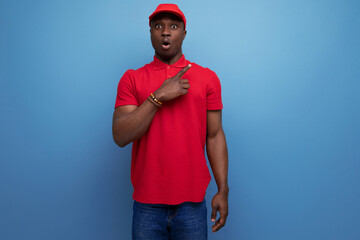 branded clothing concept. american man wearing a red t-shirt and cap on the background of ss copy...