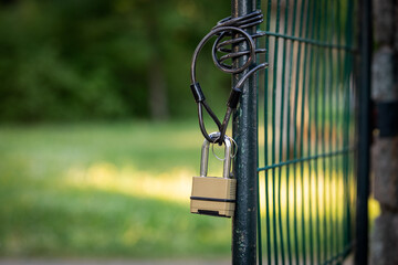 Open metal territory gate. Padlock with chain